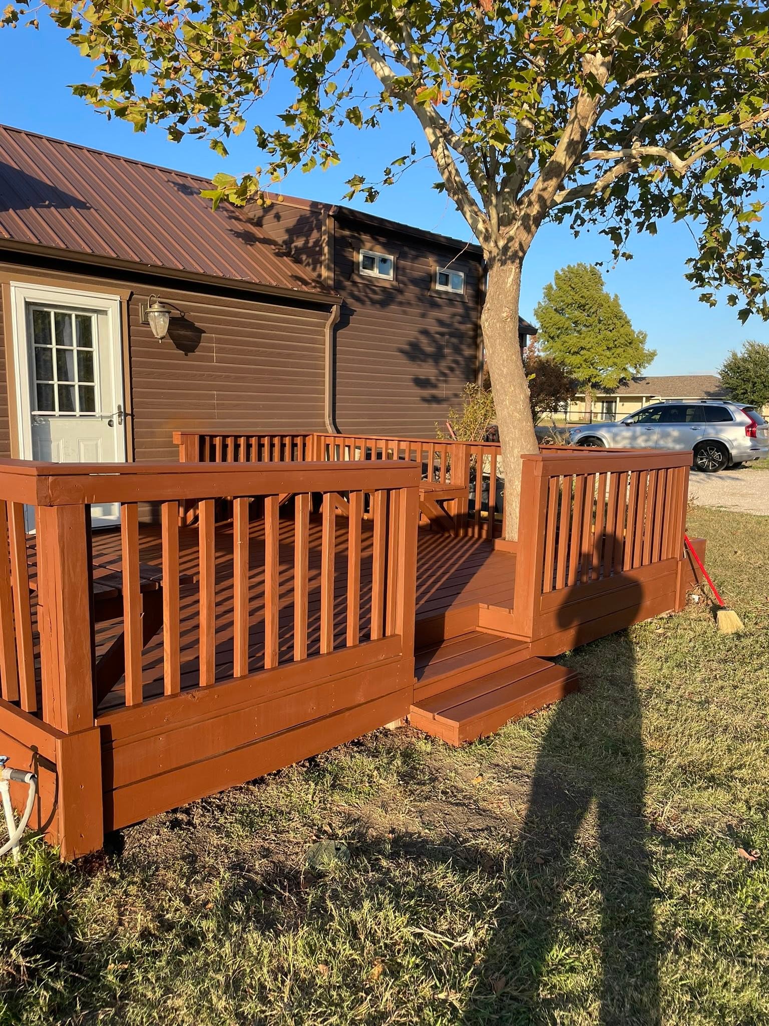 Custom backyard wood deck with stained finish, built by Andrades GC