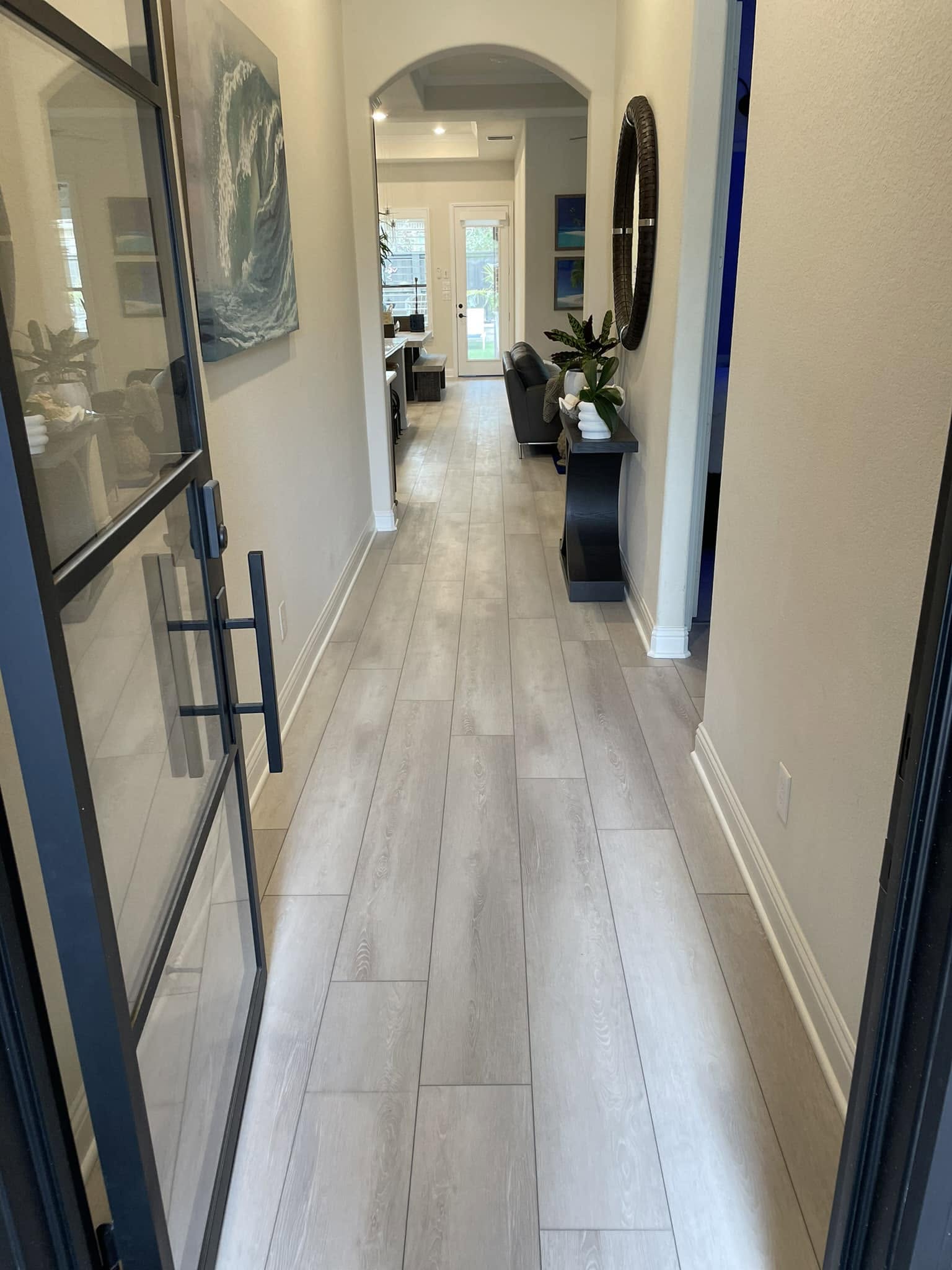 Light wood-look tile flooring installation in an entryway hall, McKinney TX
