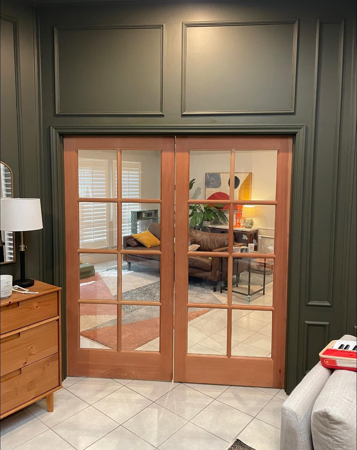 Interior French doors against a deep green accent wall, finish carpentry by Andrades GC