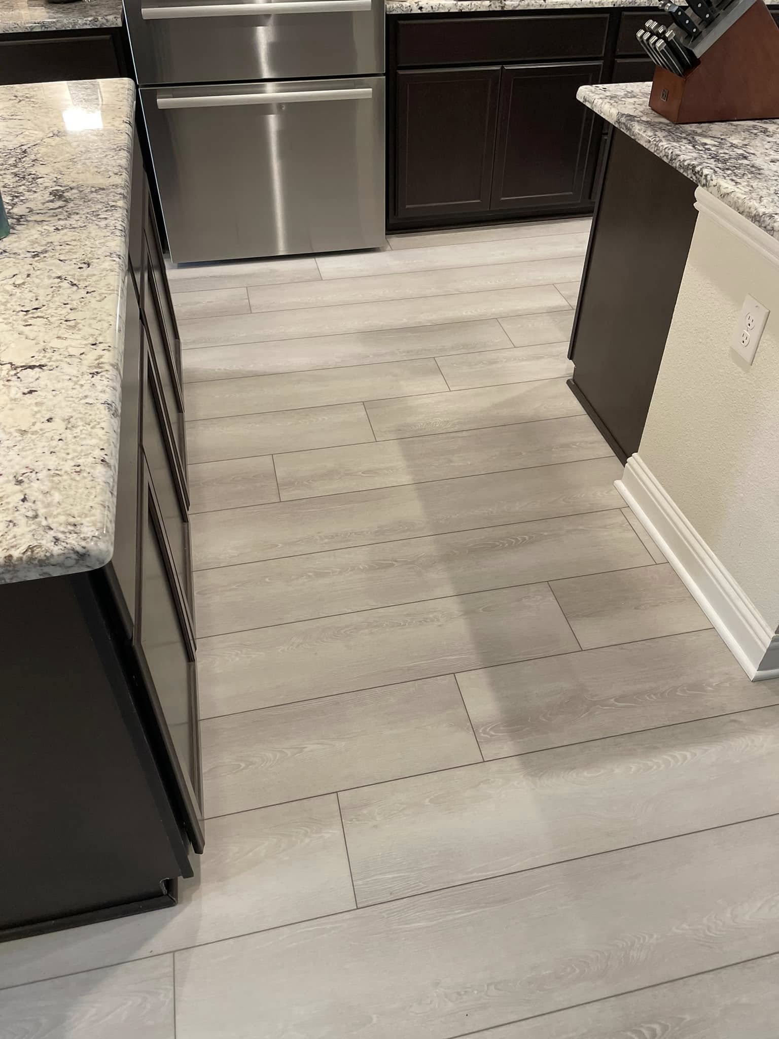 Wood-look porcelain tile floor installation in a kitchen with granite countertops, Collin County TX